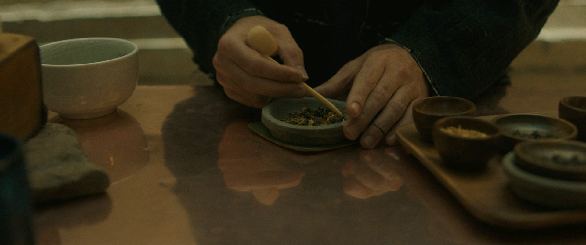 After Yang screenshot- Jake preparing tea, his ring finger is tattooed with a ring above the high knuckle.