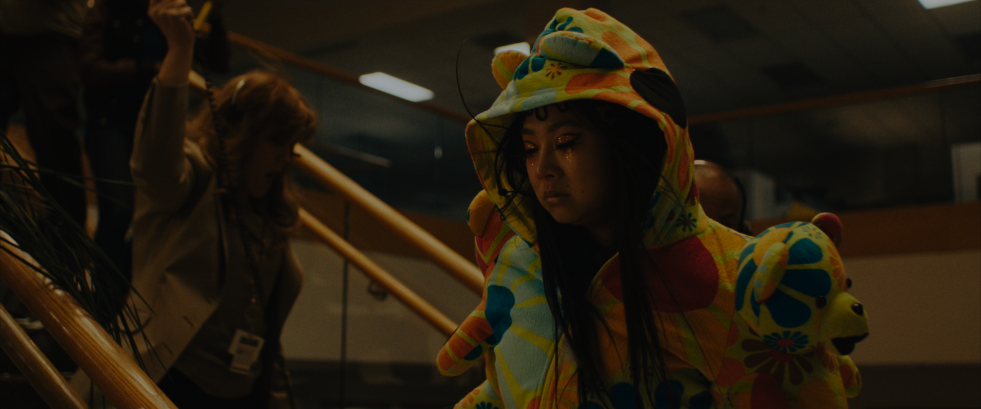 EEAAO Screenshot- Raver Jobu, wearing a teddybear hoodie with the hood up, revealing bear ears, and cut crease makeup details